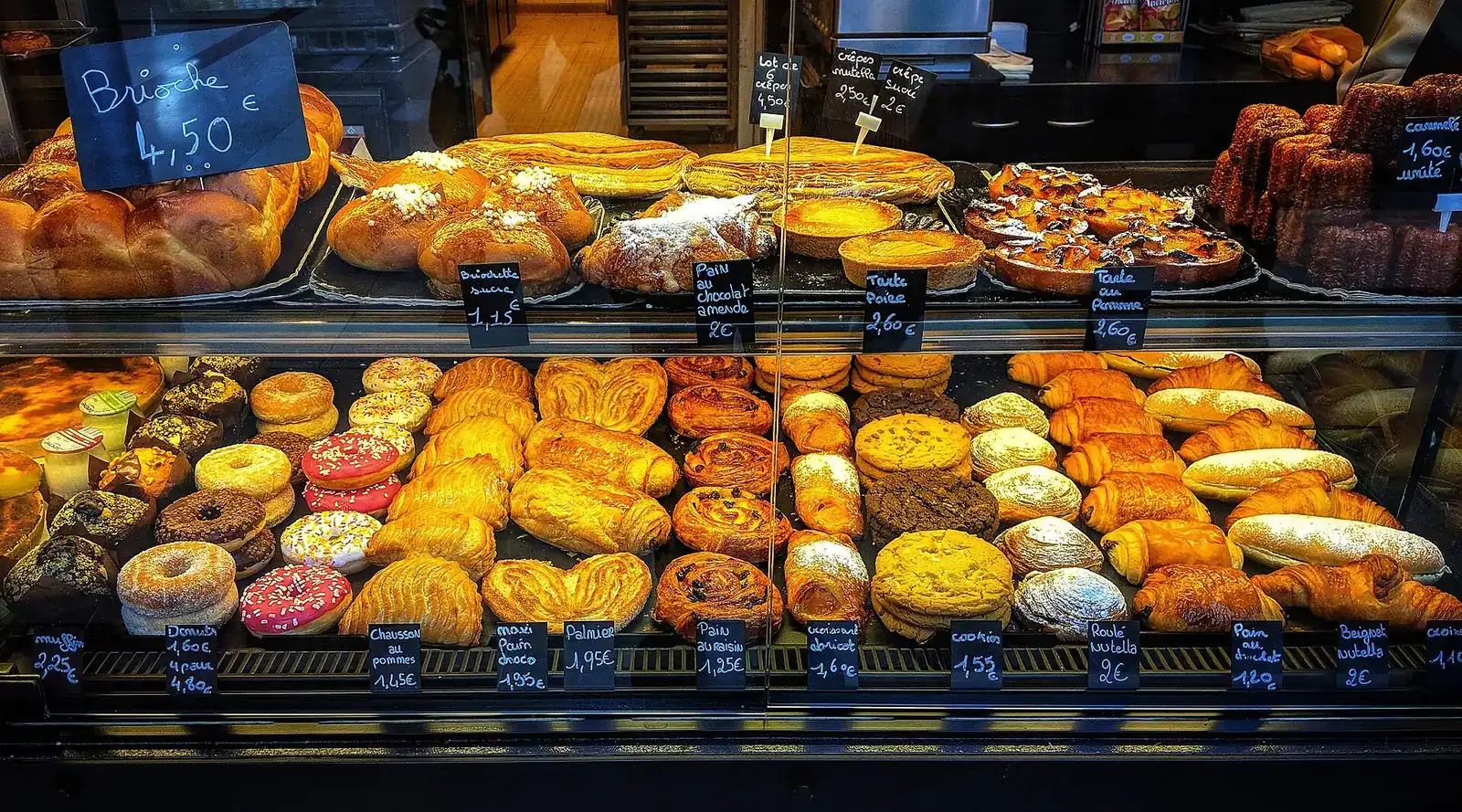 Pastries in a bakery display case in France.