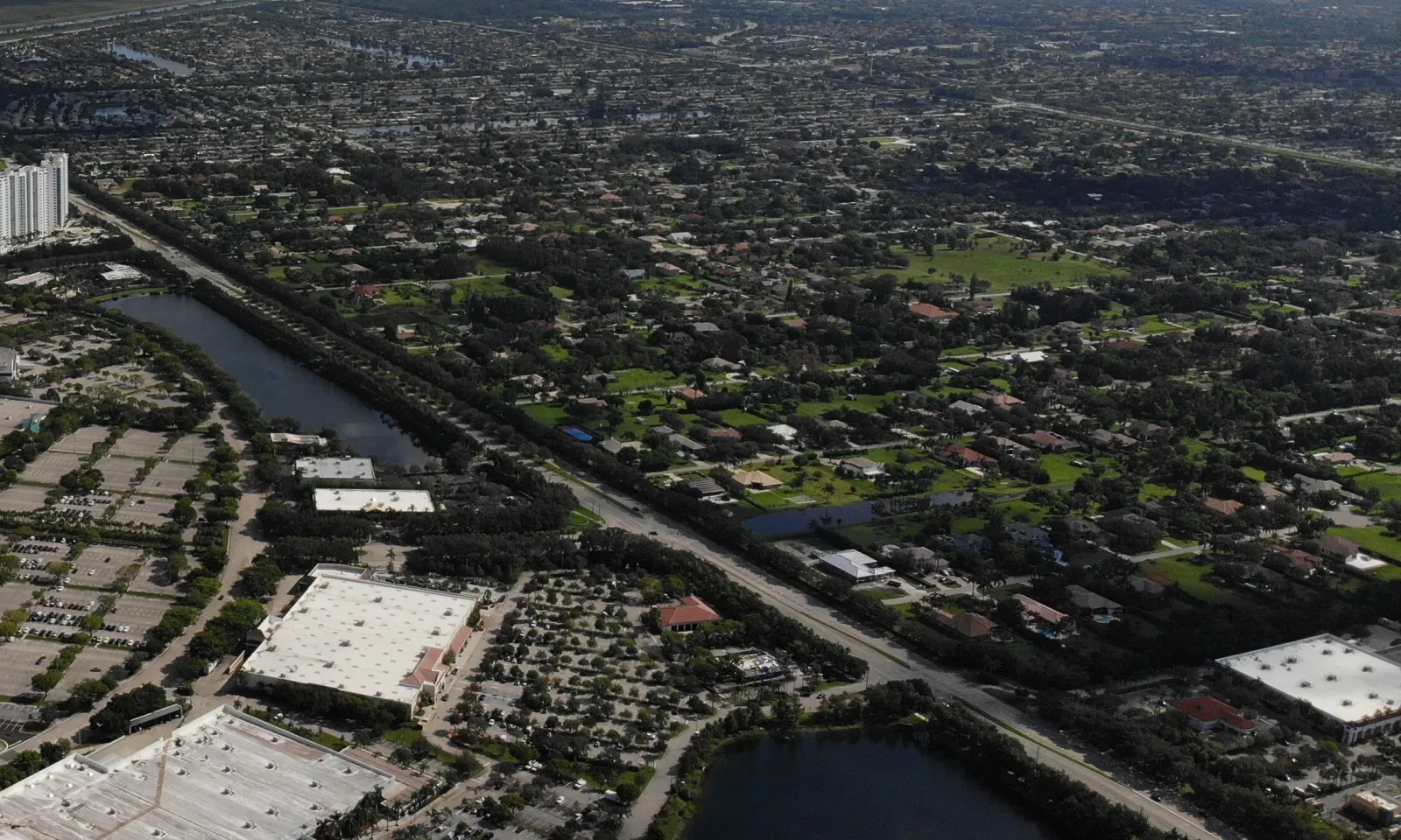 Large-lot homes in Plantation, right, across Flamingo Road from shopping centers in Sunrise, seen from the air.