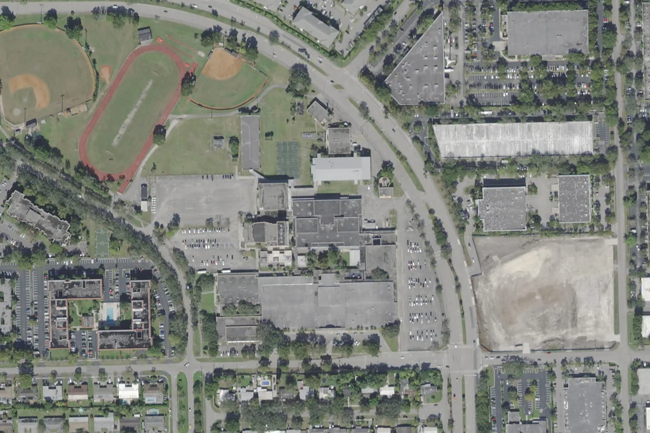 The Plantation High campus on NW 16th Street in Plantation, with its track and ball fields to the northwest, seen from the air.