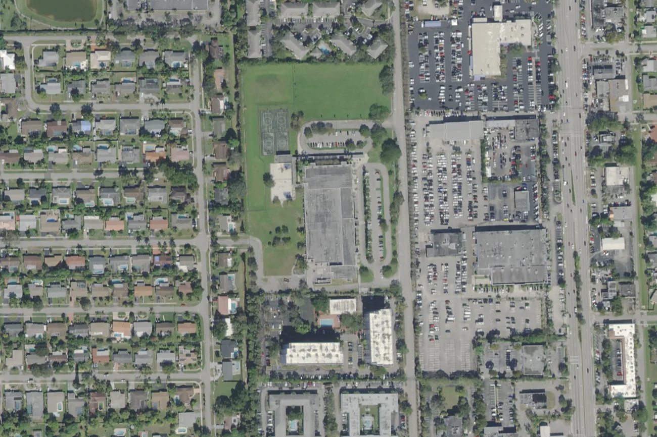Plantation Elementary School's campus on NW 42nd Avenue in east Plantation, center, west of the State Road 7 shopping plazas, seen from the air.